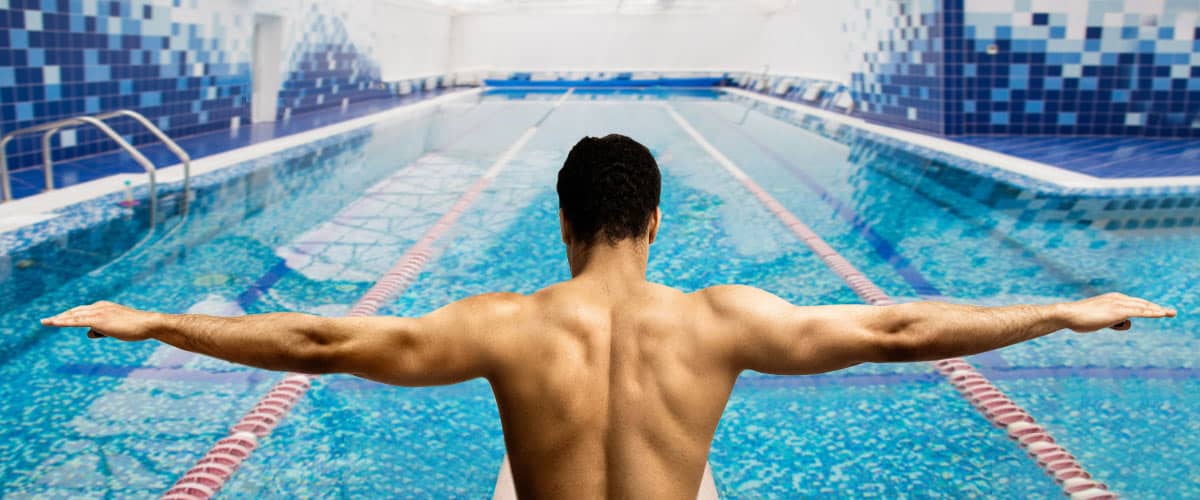 man preparing to dive into pool